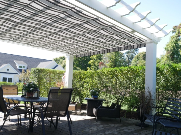 A simple fiberglass pergola beside a pool